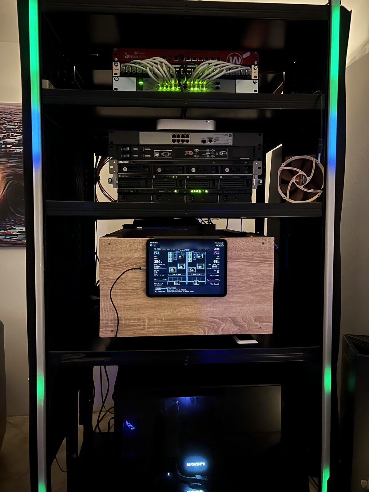 A rack with the wooden server box and an iPad showing live server telemetry
